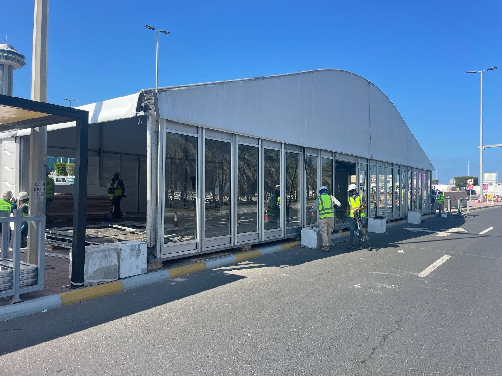 Curved-roof structure tent being installed roadside by the Toko crew